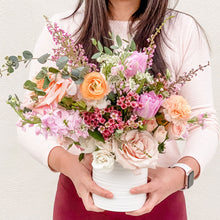 Load image into Gallery viewer, Model holding Flower Lab Design's signature Valentine's Day vased arrangement. - Sweet Treat, Arranged