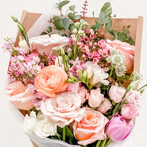 flower bouquet designed with rose, ranunculus, freesia, tulip, and waxflower - Sweet Treat, Wrapped